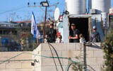 Jewish residents are seen on a rooftop in the West Bank city of Hebron after moving in, February 20, 2026. (Wisam Hashlamoun/Flash90)