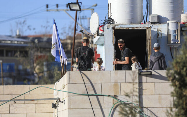 Jewish residents are seen on a rooftop in the West Bank city of Hebron after moving in, February 20, 2026. (Wisam Hashlamoun/Flash90) Jewish residents are seen on a rooftop in the West Bank city of Hebron after moving in, February 20, 2026. (Wisam Hashlamoun/Flash90)