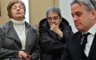 Carol Fessler, center, charged in the hit-and-run death of 4-year-old Rafael Adana, arrives for a court hearing in Petah Tikva, February 23, 2026. (Jonathan Shaul/Flash90)