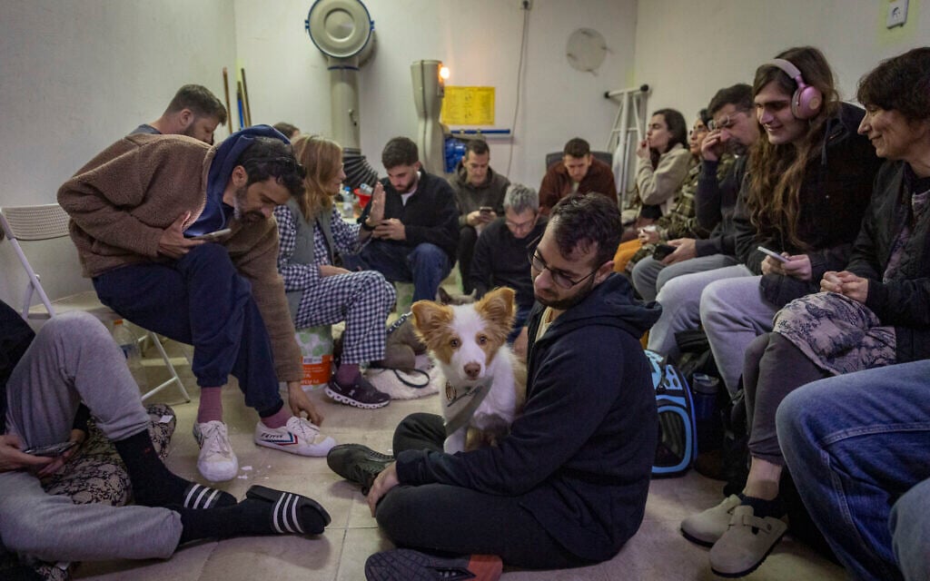 Israelis take cover in a public shelter in Tel Aviv as a siren sounds warning of incoming ballistic missiles fired from Iran toward Israel, March 1, 2026. (Chaim Goldberg/Flash90)