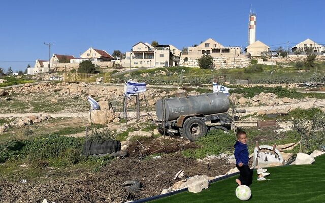 A young boy from the Palestinian hamlet of Umm al-Khair in the West Bank plays on a soccer pitch just meters from the settlement of Carmel in the background, February 2, 2026 (Jeremy Sharon/Times of Israel) A young boy from the Palestinian hamlet of Umm al-Khair in the West Bank plays on a soccer pitch just meters from the settlement of Carmel in the background, February 2, 2026 (Jeremy Sharon/Times of Israel)