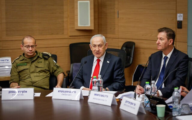 Prime Minister Benjamin Netanyahu (center), his military secretary Brig. Gen. Roman Gofman (left) and Likud MK Boaz Bismuth attend a meeting of the Knesset Foreign Affairs and Defense Committee in Jerusalem, February 5, 2026. (Noam Moskowitz/Knesset Spokeman's Office) Prime Minister Benjamin Netanyahu (center), his military secretary Brig. Gen. Roman Gofman (left) and Likud MK Boaz Bismuth attend a meeting of the Knesset Foreign Affairs and Defense Committee in Jerusalem, February 5, 2026. (Noam Moskowitz/Knesset Spokeman's Office)