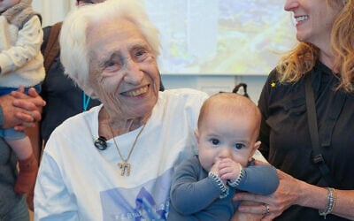 96-year-old Holocaust survivor Charlotte Roth celebrates her immigration to Israel with one of her great-great-grandchildren, February 18, 2026 (Nefesh B'Nefesh)