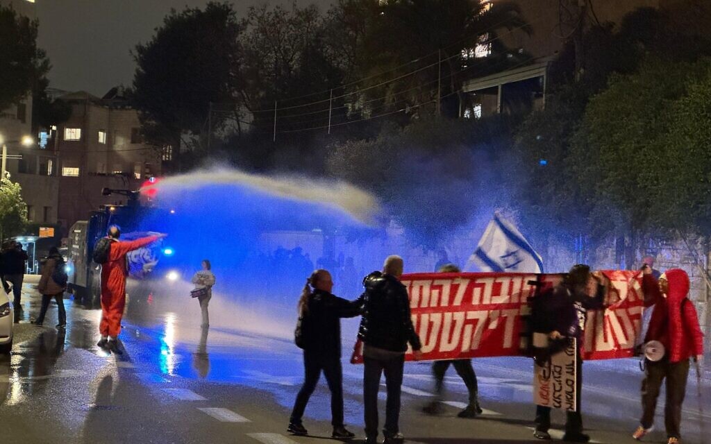 Police use a water cannon to disperse anti-government protesters at the prime minister's residence in Jerusalem on February 21, 2026. (Vardit Alon-Korpel/Israel Pro-Democracy Protest Movement) Police use a water cannon to disperse anti-government protesters at the prime minister's residence in Jerusalem on February 21, 2026. (Vardit Alon-Korpel/Israel Pro-Democracy Protest Movement)