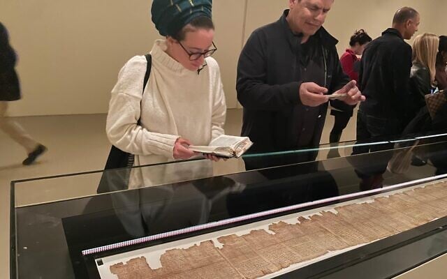 The exhibition 'A Voice from the Desert - The Great Isaiah Scroll' is inaugurated at the Israel Museum on February 23, 2026. In the image, people admire the seven-meter-long scroll in a special climate-controlled room. (Rossella Tercatin/Times of Israel) The exhibition 'A Voice from the Desert - The Great Isaiah Scroll' is inaugurated at the Israel Museum on February 23, 2026. In the image, people admire the seven-meter-long scroll in a special climate-controlled room. (Rossella Tercatin/Times of Israel)
