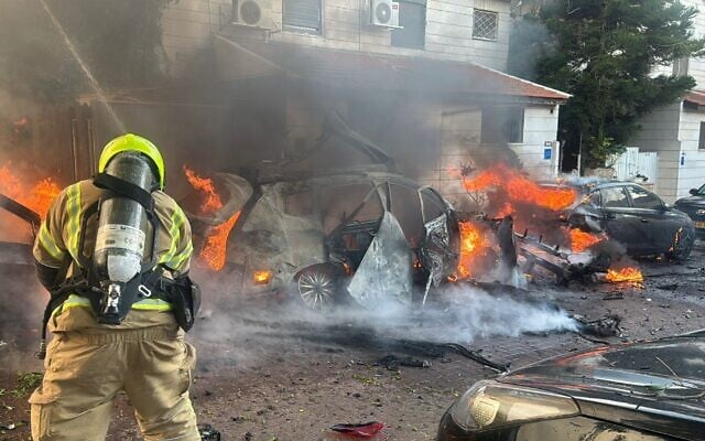 Firefighters work to extinguish a blaze sparked by missile fragments from an Iranian missile in central Israel on February 28, 2026. (Fire and Rescue Service) Firefighters work to extinguish a blaze sparked by missile fragments from an Iranian missile in central Israel on February 28, 2026. (Fire and Rescue Service)