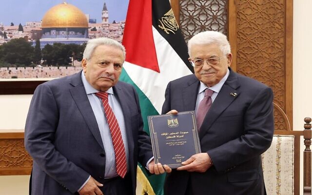 Palestinian Authority President Mahmoud Abbas receives a draft of the State of Palestine's interim constitution from counselor Muhammad al-Hajj Qasim in Ramallah on February 5, 2026. (Wafa)