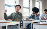 Illustrative: A high school student looks to another student for answers during an assignment (iStock by Getty Images)