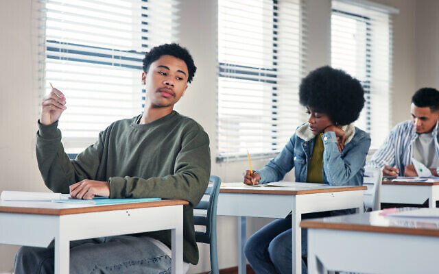 Illustrative: A high school student looks to another student for answers during an assignment (iStock by Getty Images) Illustrative: A high school student looks to another student for answers during an assignment (iStock by Getty Images)