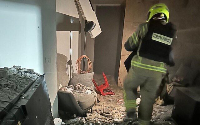 A firefighter is seen inside a house in Moshav Haniel in central Israel, after it was directly struck amid an Iranian-Hezbollah attack, early March 12, 2026. (Israel Fire and Rescue Service) A firefighter is seen inside a house in Moshav Haniel in central Israel, after it was directly struck amid an Iranian-Hezbollah attack, early March 12, 2026. (Israel Fire and Rescue Service)