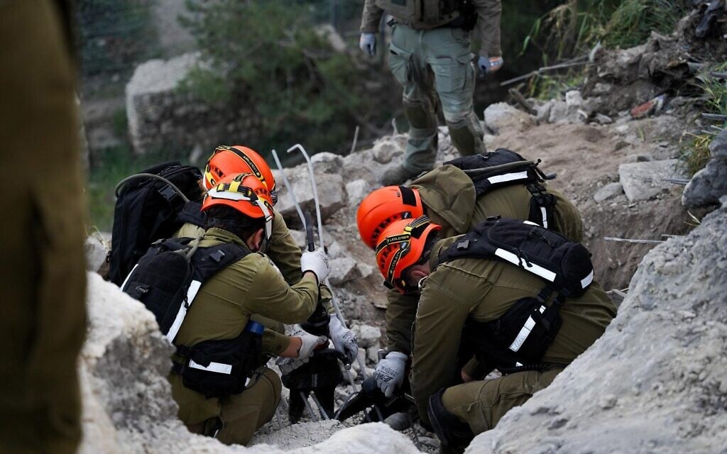 Israeli security personnel at the scene where a fragment from an intercepted Iranian ballistic missile impacted in the Jewish Quarter of Jerusalem's Old City on March 20, 2026, damaging a road and a wall. (IDF Spokesman)