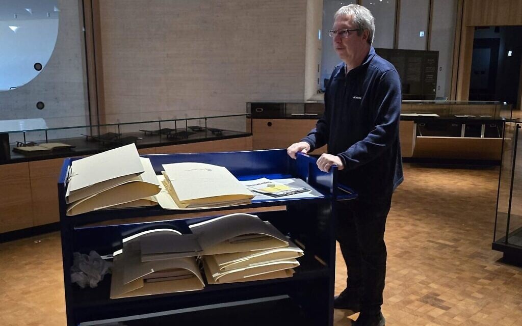 National Library of Israel CEO Oren Weinberg removing items from the permanent exhibition gallery to be taken to safekeeping on February 28, 2026 (Courtesy)