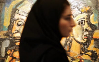 An Iranian woman passes by Georges Rouault painting "Trio-Cirque" (1928) displayed at the Modern Art Movement exhibition at Tehran's Museum of Contemporary Art, September 1, 2005. (BEHROUZ MEHRI / AFP)