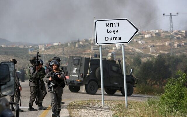 Illustrative: Israeli border police keep watch on the main road leading to the Palestinian village of Duma in the West Bank, on April 5, 2016. (MENAHEM KAHANA / AFP) Illustrative: Israeli border police keep watch on the main road leading to the Palestinian village of Duma in the West Bank, on April 5, 2016. (MENAHEM KAHANA / AFP)
