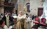 Father Pierre al-Rai leads mass at a church in the village of Qlayaa, on the southern border with Israel, on December 21, 2023. (AFP)