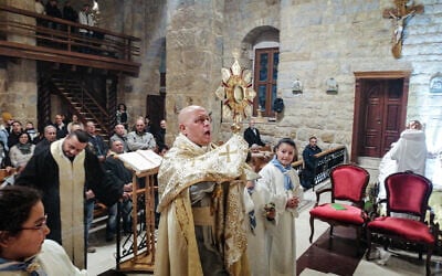 Father Pierre al-Rai leads mass at a church in the village of Qlayaa, on the southern border with Israel, on December 21, 2023. (AFP) Father Pierre al-Rai leads mass at a church in the village of Qlayaa, on the southern border with Israel, on December 21, 2023. (AFP)
