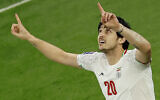 Iran's forward Sardar Azmoun celebrates after scoring his team's first goal during the Qatar 2023 AFC Asian Cup semi-final football match between Iran and Qatar at al-Thumama Stadium in Doha on February 7, 2024 (Karim Jaafar / AFP)