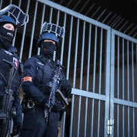Illustrative: Armed police stand guard on April 1, 2025 at the compound of the court building in Celle, northern Germany. (RONNY HARTMANN / POOL / AFP)