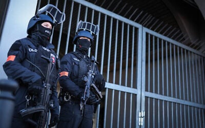 Illustrative: Armed police stand guard on April 1, 2025 at the compound of the court building in Celle, northern Germany. (RONNY HARTMANN / POOL / AFP) Illustrative: Armed police stand guard on April 1, 2025 at the compound of the court building in Celle, northern Germany. (RONNY HARTMANN / POOL / AFP)