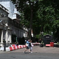 People walk past the gated entrance to the road housing the Israeli embassy in London on June 15, 2025. (Justin Tallis/AFP)