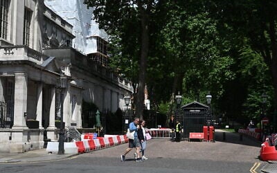 People walk past the gated entrance to the road housing the Israeli embassy in London on June 15, 2025. (Justin Tallis/AFP)