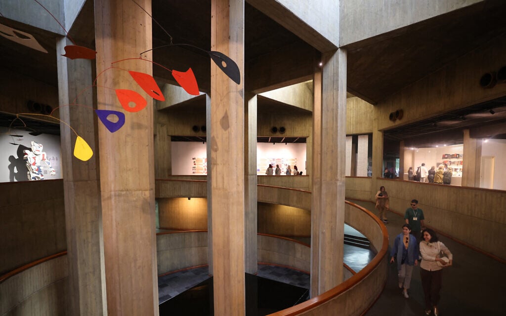 People tour the Tehran Museum of Contemporary Art on August 10, 2025, during an exhibit titled "In Women's Words", which showcases works by modern Iranian women artists. (ATTA KENARE / AFP)