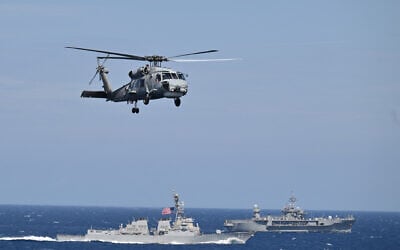 A picture taken from the Turkish Navy drone-carrying amphibious assault ship, TCG ANADOLU (L-400) shows a helicopter flying over the USS destroyer Roosevelt (L) and the USS command and control ship Mount Whitney during NATO's premier enhanced Vigilance Activity (eVA) Neptune Strike 2025-3 in the Adriatic Sea on September 24, 2025. (Alberto Pizzoli/AFP) A picture taken from the Turkish Navy drone-carrying amphibious assault ship, TCG ANADOLU (L-400) shows a helicopter flying over the USS destroyer Roosevelt (L) and the USS command and control ship Mount Whitney during NATO's premier enhanced Vigilance Activity (eVA) Neptune Strike 2025-3 in the Adriatic Sea on September 24, 2025. (Alberto Pizzoli/AFP)