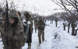 Syrian soldiers stand in the snow in the country's mountainous Qalamoun region, near the border with Lebanon, during a patrol to secure the frontier and prevent smuggling operations on January 1, 2026. (Bakr ALkasem / AFP)