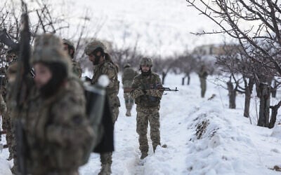 Syrian soldiers stand in the snow in the country's mountainous Qalamoun region, near the border with Lebanon, during a patrol to secure the frontier and prevent smuggling operations on January 1, 2026. (Bakr ALkasem / AFP)