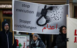 Protesters display a banner calling for a halt to executions in Iran during a rally in Berlin, Germany, on January 10, 2026, in support of the Iran protests. (John MacDougall / AFP)