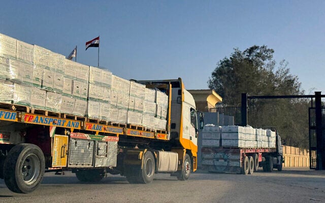 Humanitarian aid trucks enter through the Egyptian side of the Rafah border crossing with the Gaza Strip in northeastern Egypt on February 1, 2026.  (AFP)