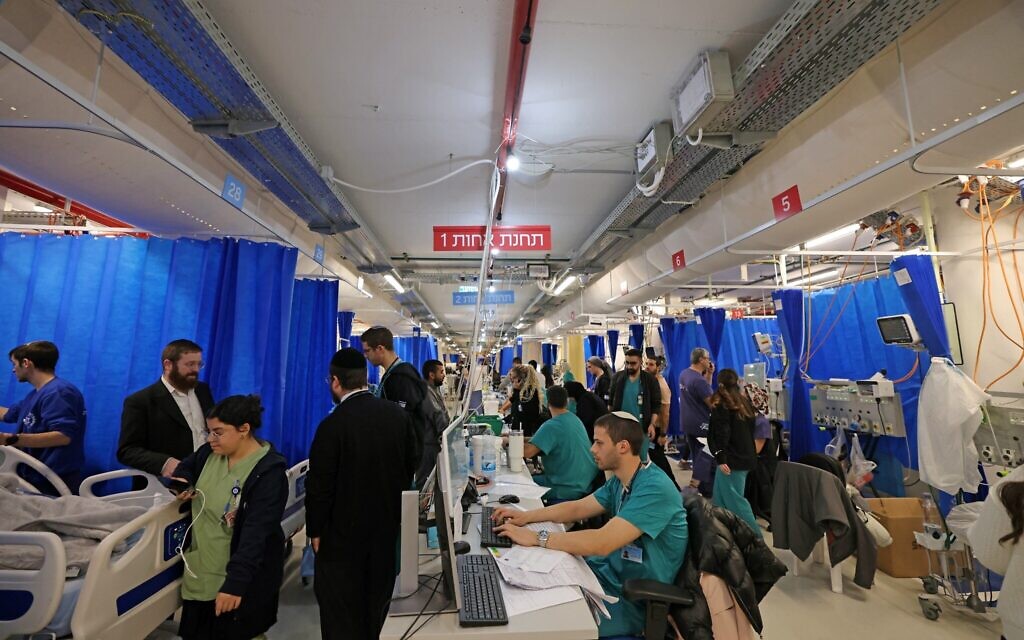 Hospital staff and patients work in a ward that has been relocated to the parking lot at Hadassah Mount Scopus Hospital for safety on March 1, 2026. (AHMAD GHARABLI / AFP)
