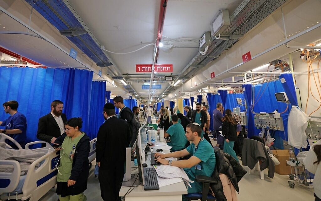 Hospital staff and patients work in a ward that relocated to the parking lot at for safety amid the US-Israeli war against Iran, at Jerusalem's Hadassah Mount Scopus Hospital, March 1, 2026. (AHMAD GHARABLI / AFP)
