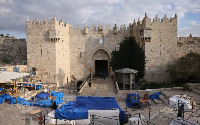 Israeli security check residents as they enter through the Damascus Gate which leads into Jerusalem's Old City on March 1, 2026. (HAZEM BADER / AFP)