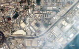 This handout satellite image taken by 2026 Planet Labs PBC on March 1, 2026 shows a view of smoke rising from damage at the US Fifth fleet naval base in Bahrain's capital Manama after it was hit by Iranian strikes. (© 2026 Planet Labs PBC / AFP)