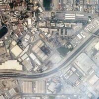 This handout satellite image taken by 2026 Planet Labs PBC on March 1, 2026 shows a view of smoke rising from damage at the US Fifth fleet naval base in Bahrain's capital Manama after it was hit by Iranian strikes. (© 2026 Planet Labs PBC / AFP)