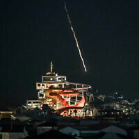 Illustrative: An intercepted projectile falls into the sea near Dubai's Palm Jumeirah archipelago on March 1, 2026. (FADEL SENNA / AFP)