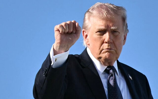 US President Donald Trump gestures as he boards Air Force One before departing Palm Beach International Airport in West Palm Beach, Florida, on March 1, 2026, on his way back to Washington, DC. (Mandel NGAN / AFP)