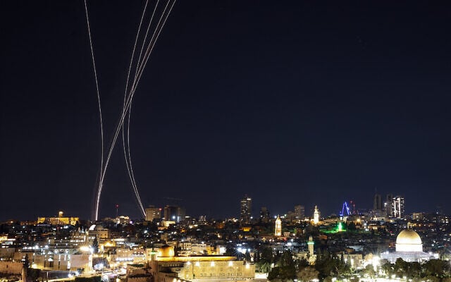Rocket trails from interceptors are pictured over Jerusalem on March 1, 2026.  (Photo by HAZEM BADER / AFP)