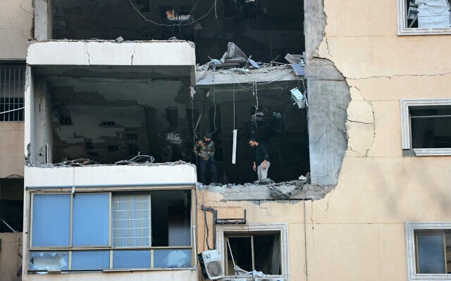 People inspect a damaged building after an Israeli airstrike in Beirut's southern suburb neighborhood of Haret Hreik on March 2, 2026. (Photo by IBRAHIM AMRO / AFP)