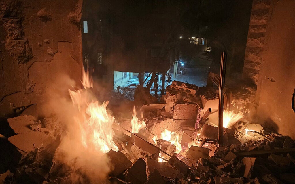 Fire erupts in a building damaged in an Israeli air strike in the southern Beirut suburb of Haret Hreik on March 2, 2026.  (Photo by AFP)