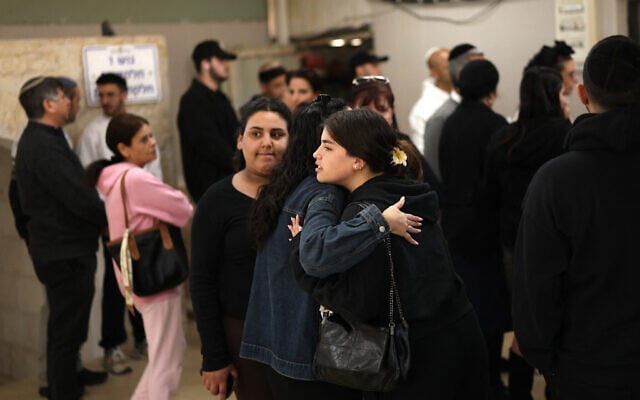 Friend and family grieve during the funeral of Oren Katz, the day after a missile attack on Bet Shemesh on March 2, 2026. (Photo by Ilia YEFIMOVICH / AFP)