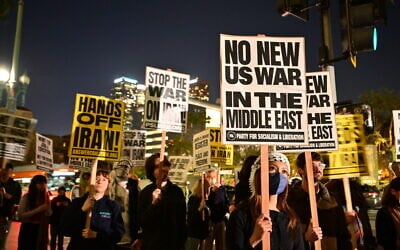 Demonstrators hold placards at a protest against military action in Iran outside City Hall in Los Angeles, California, on March 2, 2026. (Frederic J. Brown/AFP) Demonstrators hold placards at a protest against military action in Iran outside City Hall in Los Angeles, California, on March 2, 2026. (Frederic J. Brown/AFP)
