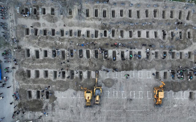 In this aerial handout picture released by the Iranian Press Center, mourners dig graves during the funeral for children killed in a reported strike on a primary school in Iran's Hormozgan province in Minab on March 3, 2026. (Iranian Press Center / AFP) In this aerial handout picture released by the Iranian Press Center, mourners dig graves during the funeral for children killed in a reported strike on a primary school in Iran's Hormozgan province in Minab on March 3, 2026. (Iranian Press Center / AFP)