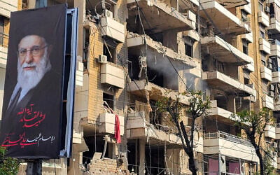 A banner of Iran's supreme leader Ayatollah Ali Khamenei is seen next to a building damaged by an Israeli strike in the southern suburbs of Beirut on March 3, 2026. (AFP)