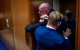 Brian McGinnis, a protester dressed in a military uniform, is removed from a US Senate Armed Services Subcommittee hearing by GOP Senator Tim Sheehy of Montana (R) and US Capitol Police officers, on Capitol Hill in Washington, DC, March 4, 2026. (Andrew Harnik/Getty Images/AFP)