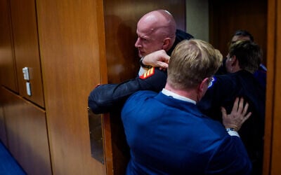 Brian McGinnis, a protester dressed in a military uniform, is removed from a US Senate Armed Services Subcommittee hearing by GOP Senator Tim Sheehy of Montana (R) and US Capitol Police officers, on Capitol Hill in Washington, DC, March 4, 2026. (Andrew Harnik/Getty Images/AFP)