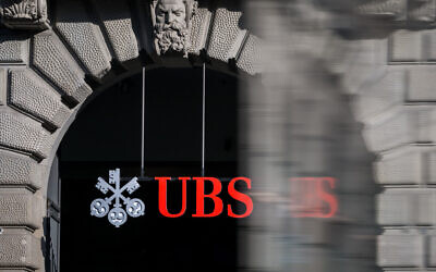 This photograph shows a sign of Swiss giant banking UBS at a branch in Zurich on March 4, 2026. (Fabrice COFFRINI / AFP)