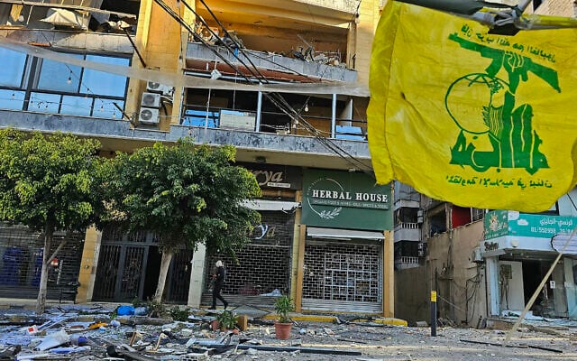 A flag of Hezbollah flutters at the site of destroyed buildings following airstrikes in Beirut's southern suburbs of Ghobeiry neighborhood, on March 5, 2026. (AFP)