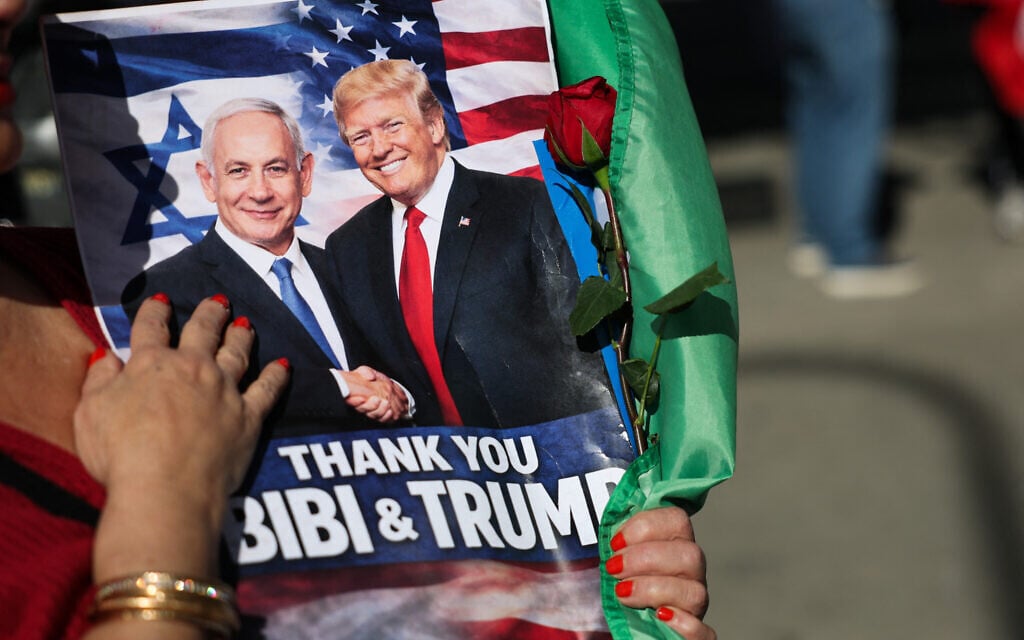 A person holds a sign supporting Prime Minister Benjamin Netanyahu and US President Donald Trump during a gathering of Iranian community members showing support for Israel and the United States, outside the Consulate General of Israel in Los Angeles, on March 5, 2026. (Patrick T. Fallon/AFP)